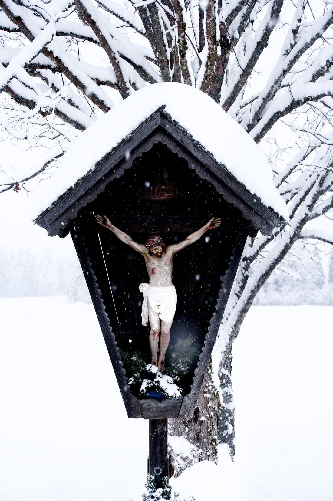 Christian cross covered in snow