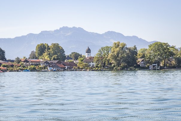 Lake Chiemsee and island of Fraueninsel in front of a mountain panorama
